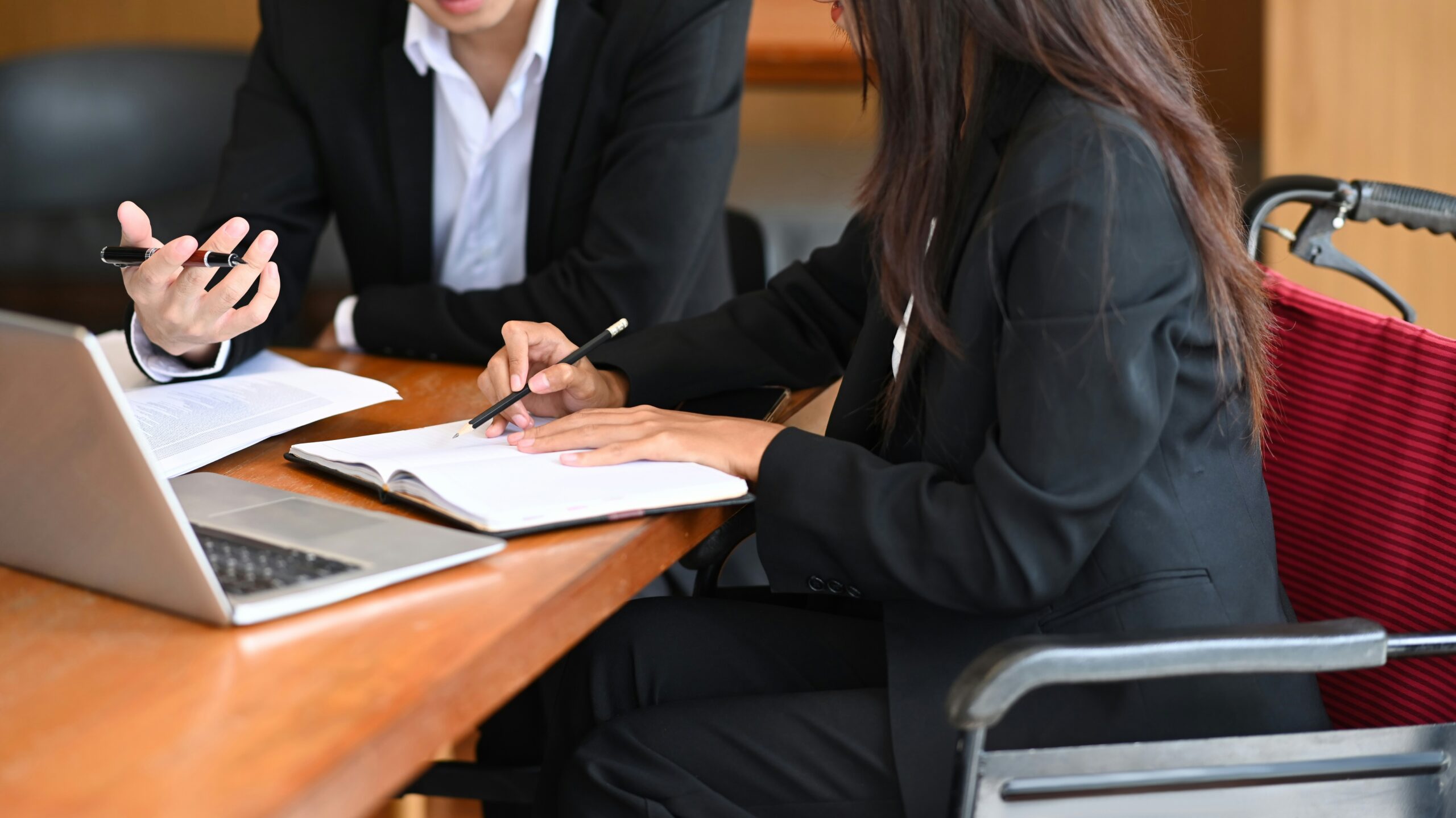 Parent and child with an attorney reviewing special needs trust documents