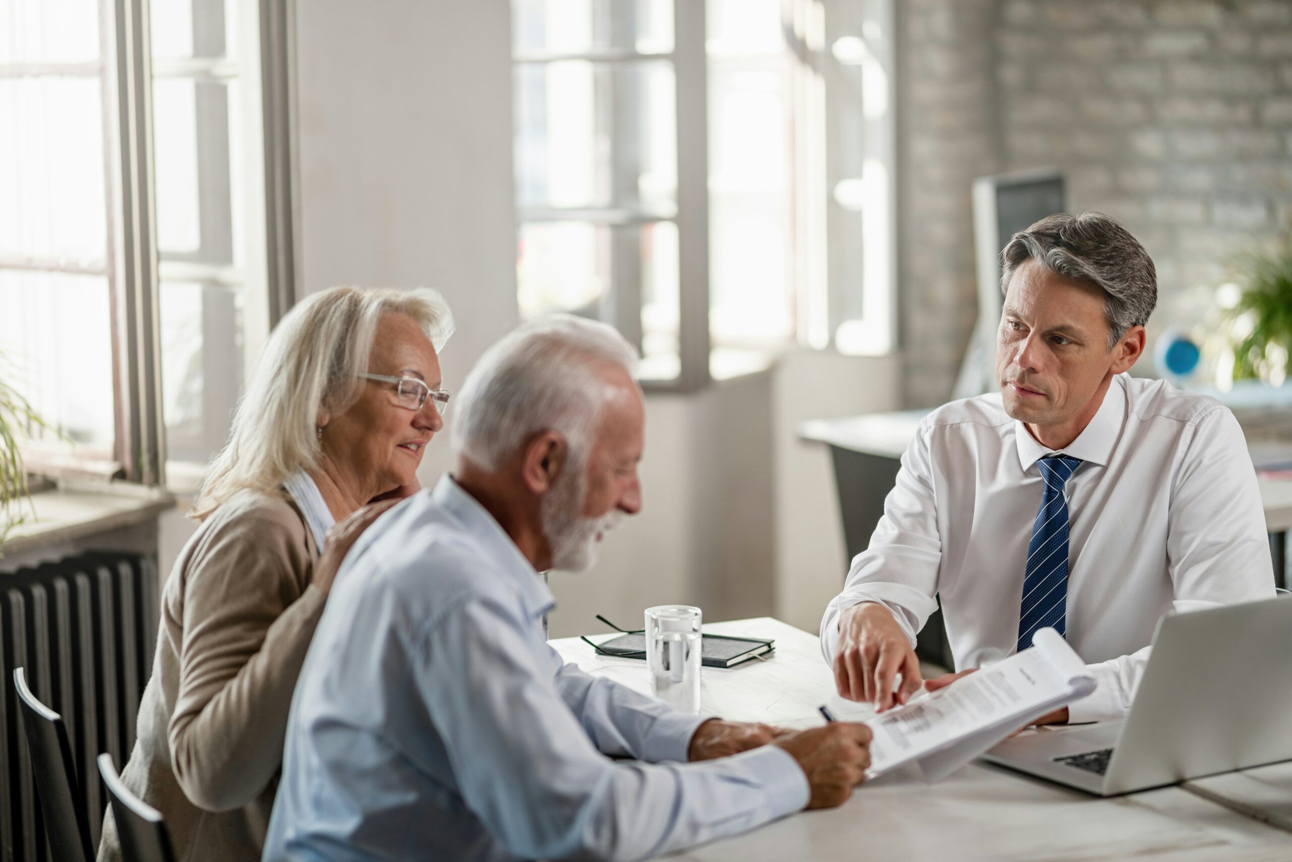Elder law attorney meeting with Arkansas couple to review long-term care planning documents